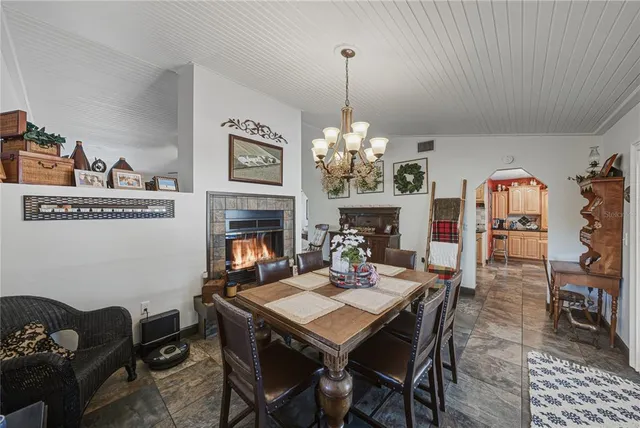 a view of a dining room with furniture a chandelier and wooden floor
