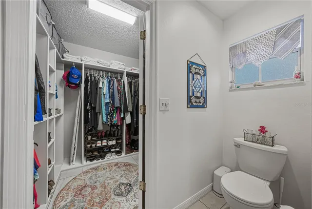 a view of walk in closet with clothes