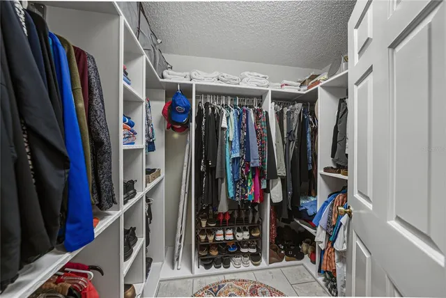 a bed room with a bed and a chair