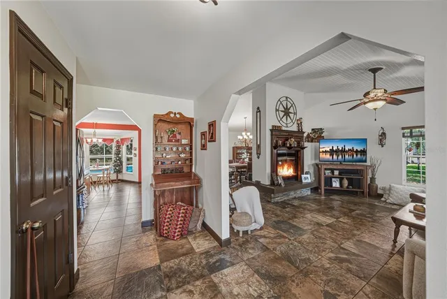 a living room with fireplace furniture and a flat screen tv