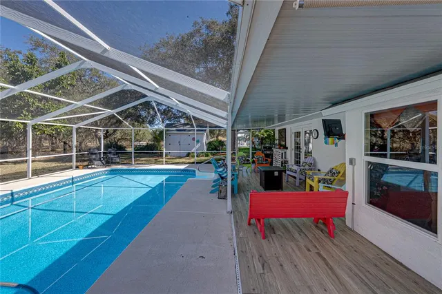 a view of a house with a yard and sitting area