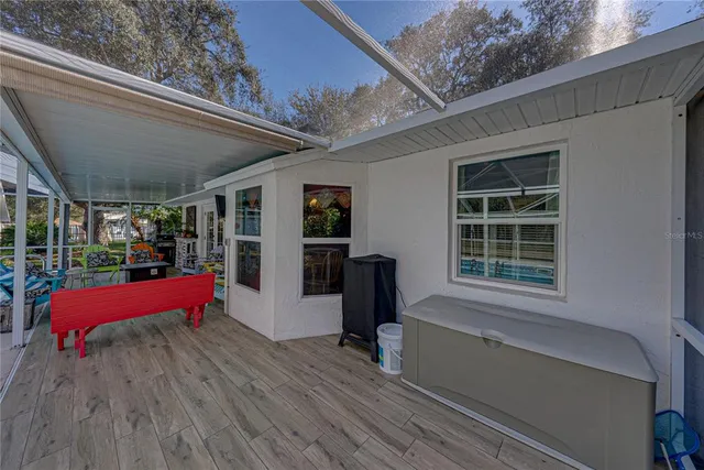 a view of a small house with potted plants
