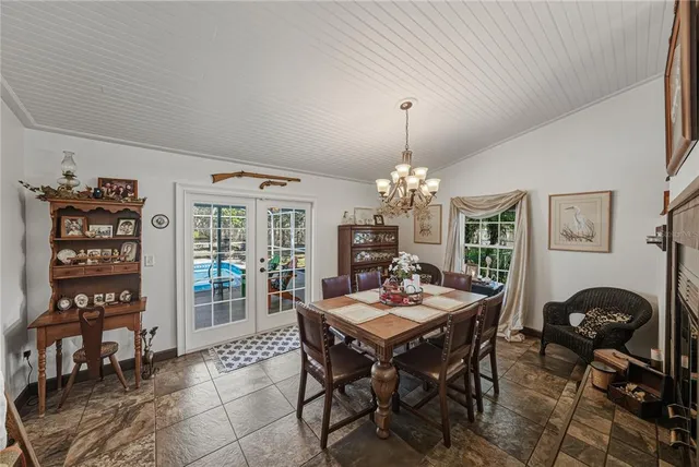 a view of a dining room with furniture and chandelier