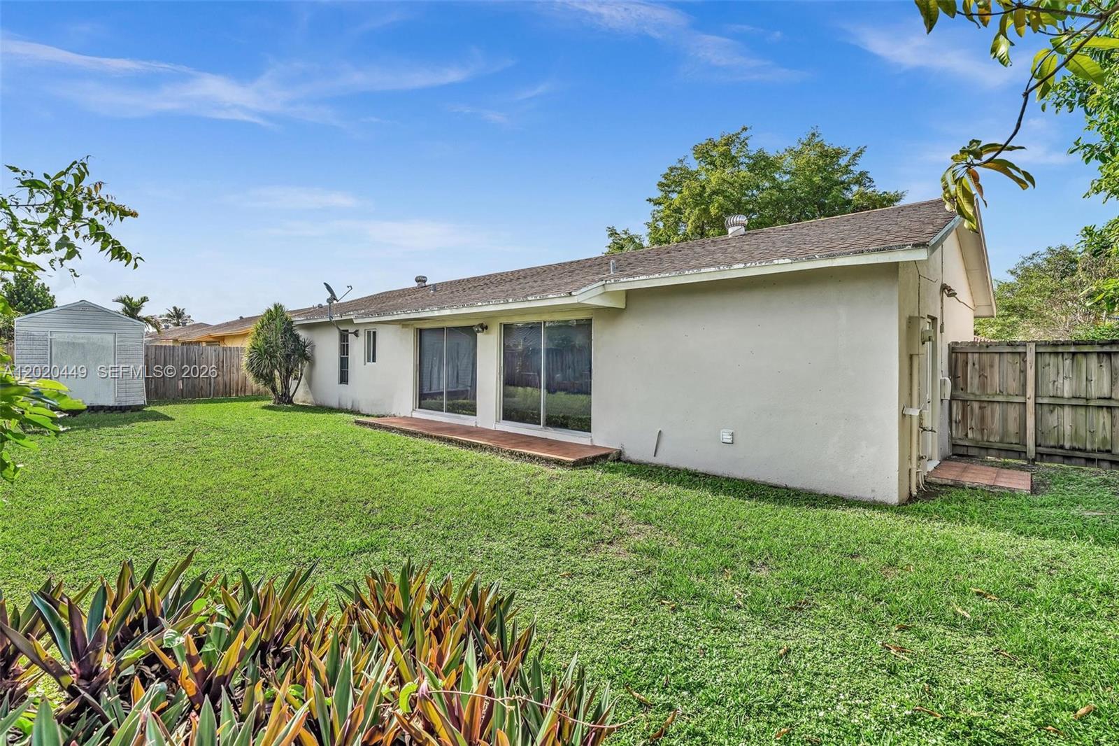 11061 Southwest 163rd Street Miami, FL 33157 - Photo 24 of 42 a view of a house with a yard and a garden