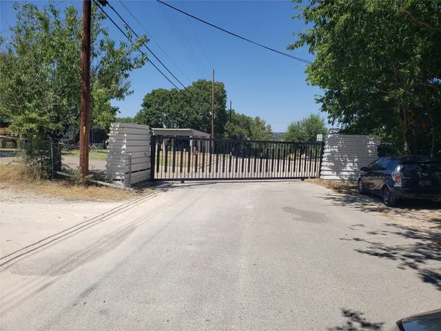 a view of backyard with deck and wooden fence