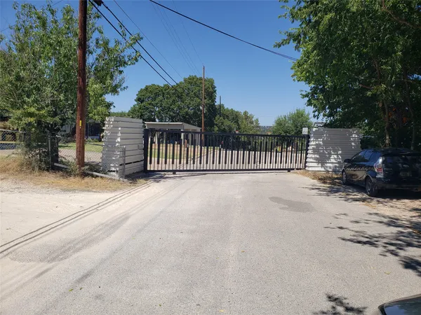 a view of backyard with deck and wooden fence