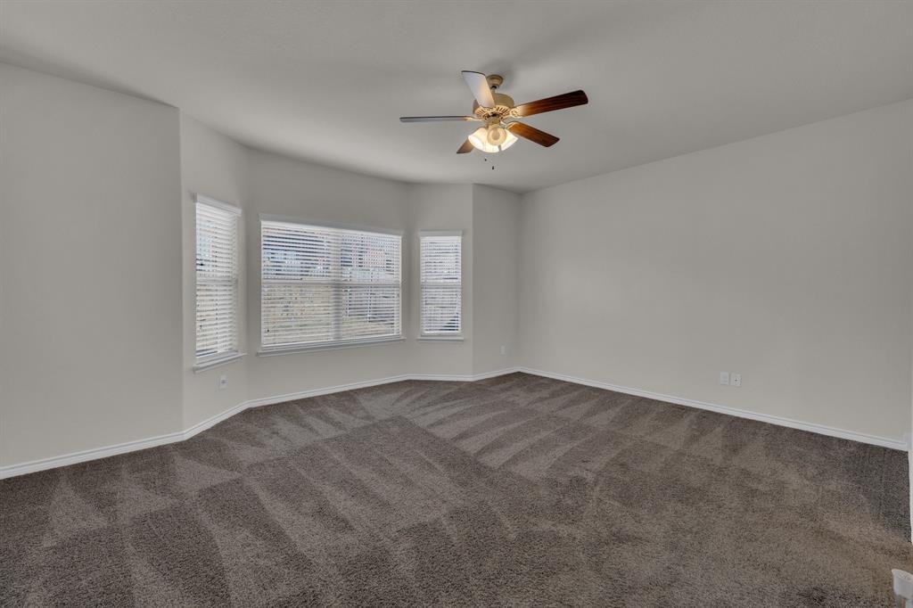 610 Bassett Hall Road Fate, TX 75189 - Photo 16 of 28 Unfurnished room with dark carpet and ceiling fan