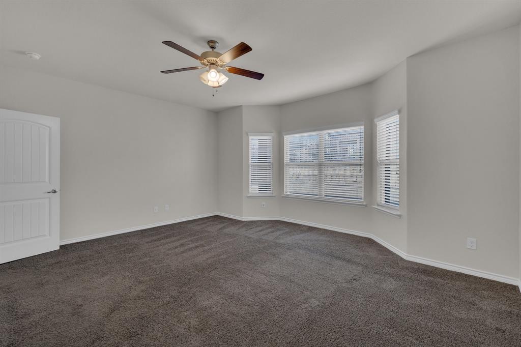 610 Bassett Hall Road Fate, TX 75189 - Photo 17 of 28 Unfurnished room with ceiling fan and dark colored carpet