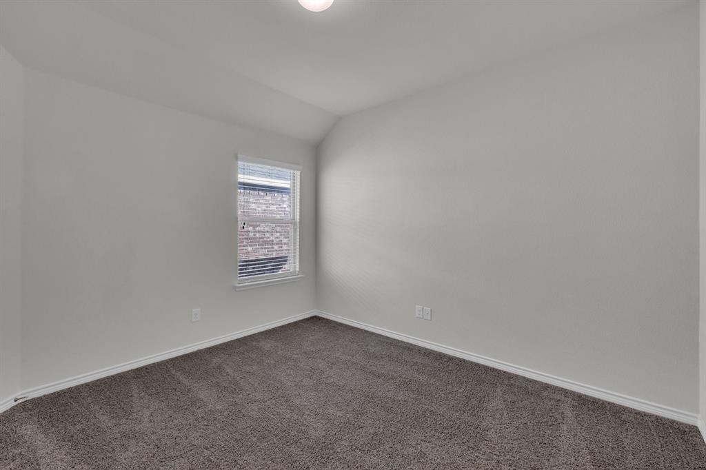 610 Bassett Hall Road Fate, TX 75189 - Photo 24 of 28 Carpeted empty room featuring lofted ceiling