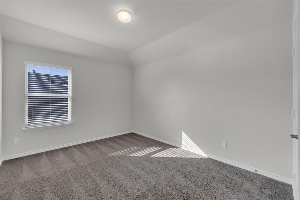 610 Bassett Hall Road Fate, TX 75189 - Photo 25 of 28 Carpeted empty room featuring lofted ceiling