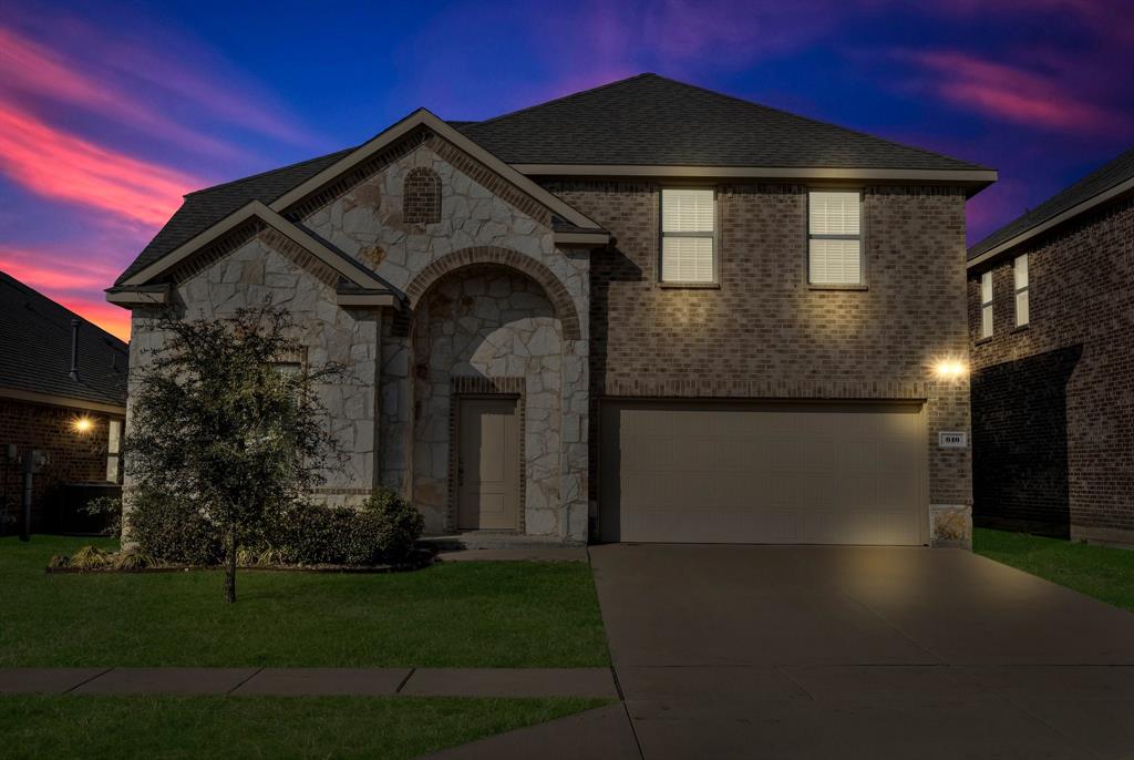 610 Bassett Hall Road Fate, TX 75189 - Photo 28 of 28 View of front facade with a garage and a lawn