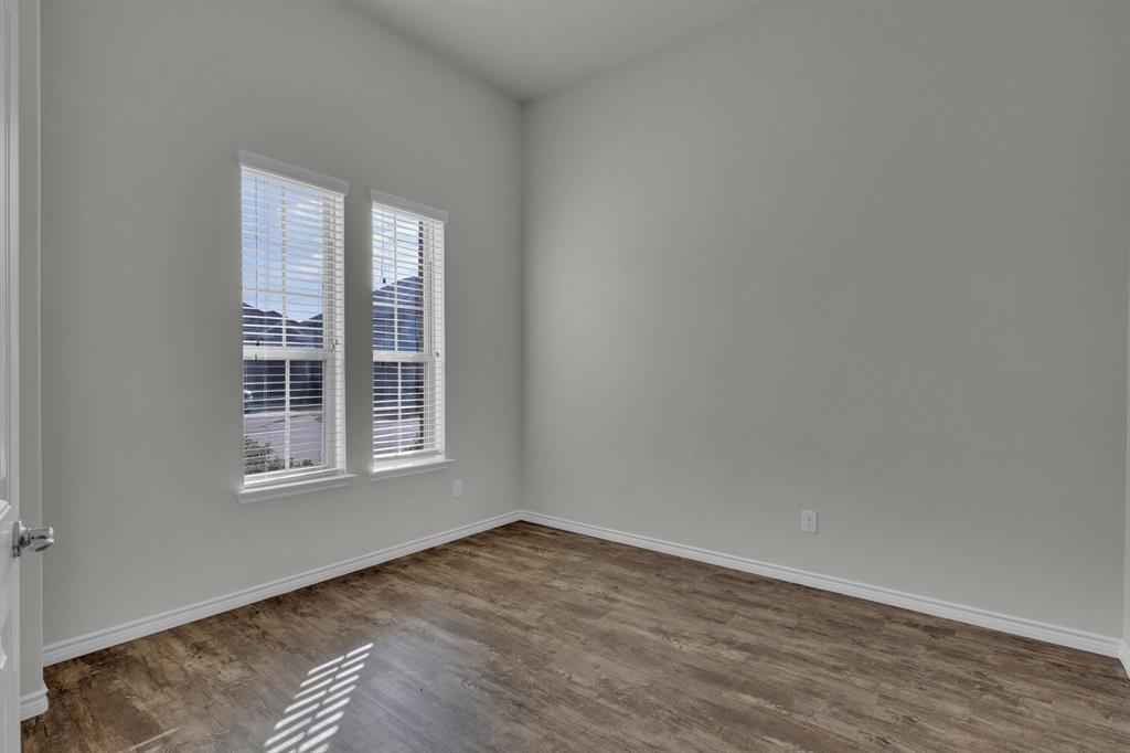 610 Bassett Hall Road Fate, TX 75189 - Photo 5 of 28 Empty room with dark wood-type flooring