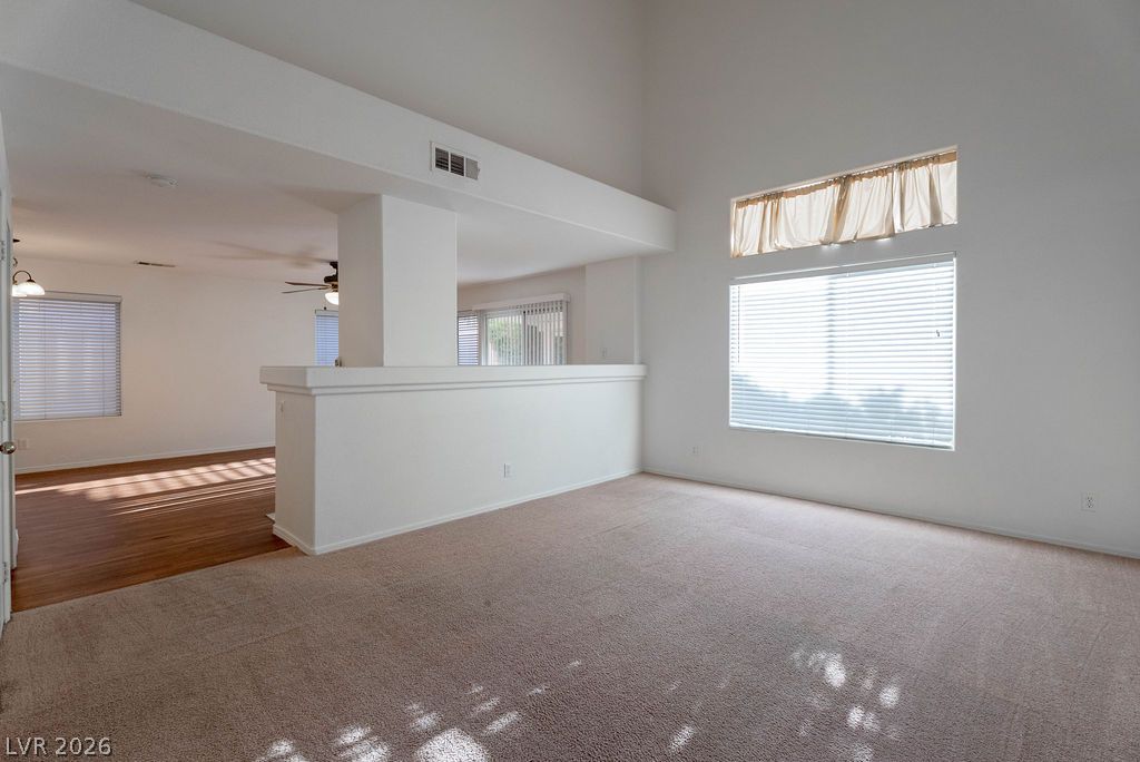 8379 Rockefeller Street Las Vegas, NV 89123 - Photo 2 of 36 High ceilings and tall windows create an airy atmosphere in this versatile living space.