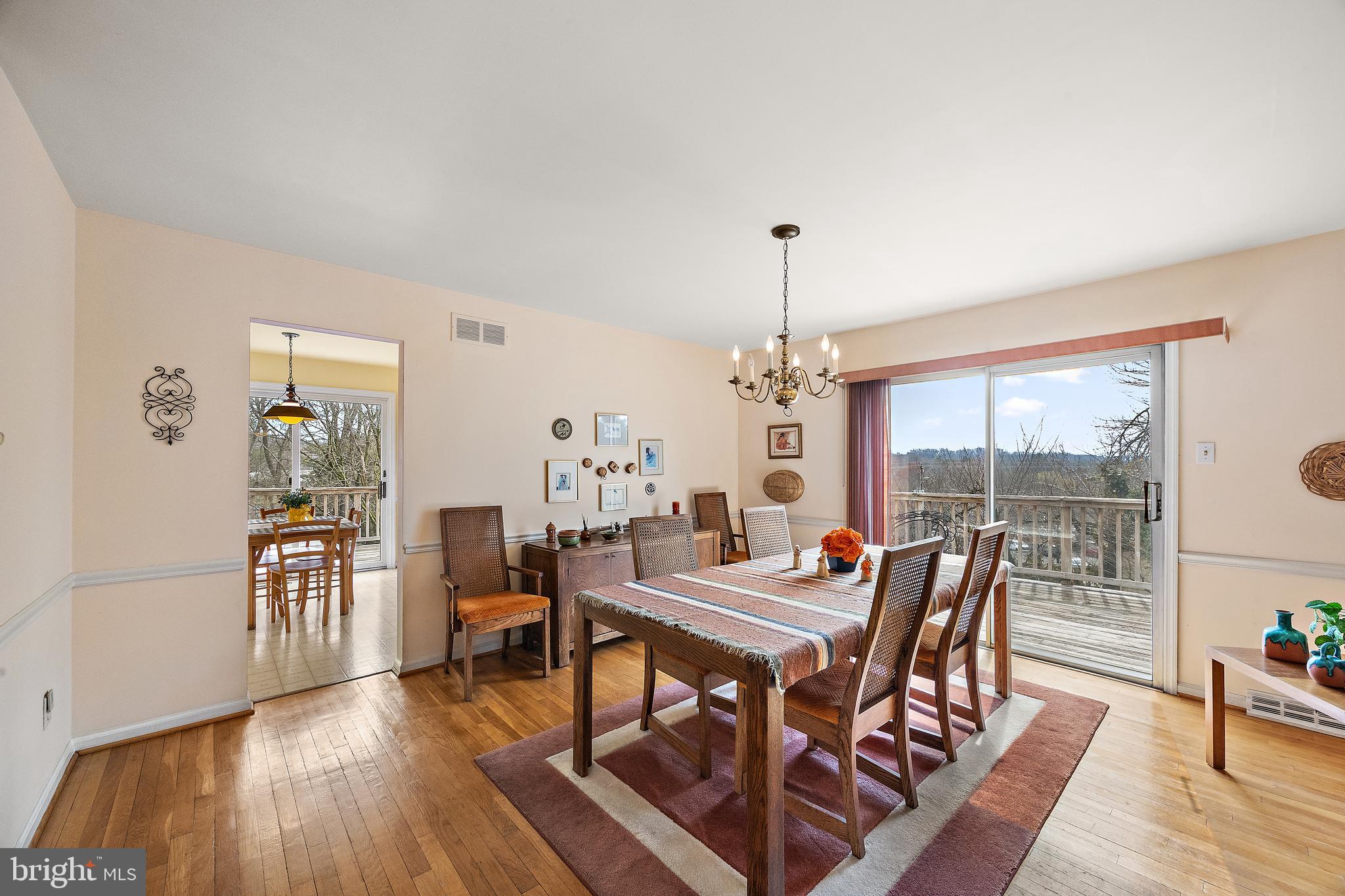 509 Holly Knoll Road Hockessin, DE 19707 - Photo 15 of 34 a dining room with furniture a chandelier and wooden floor