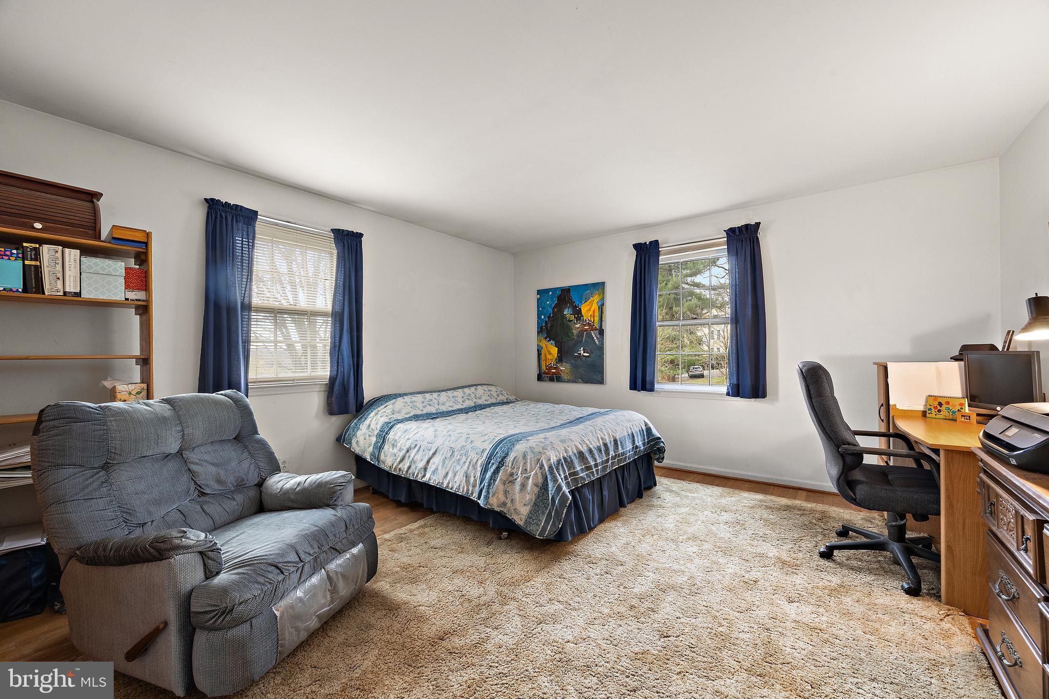 509 Holly Knoll Road Hockessin, DE 19707 - Photo 19 of 34 a spacious bedroom with a bed a couch and a window