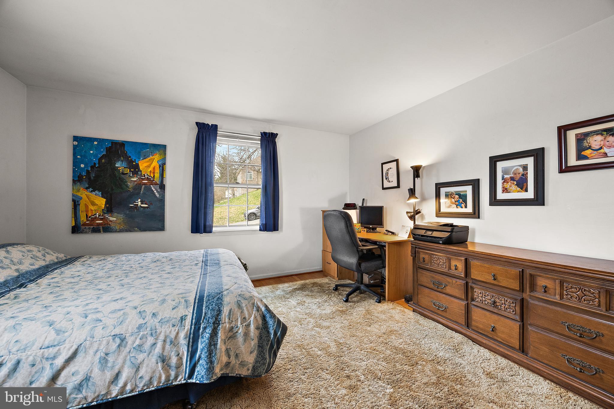 509 Holly Knoll Road Hockessin, DE 19707 - Photo 21 of 34 a bedroom with a bed and wooden furniture