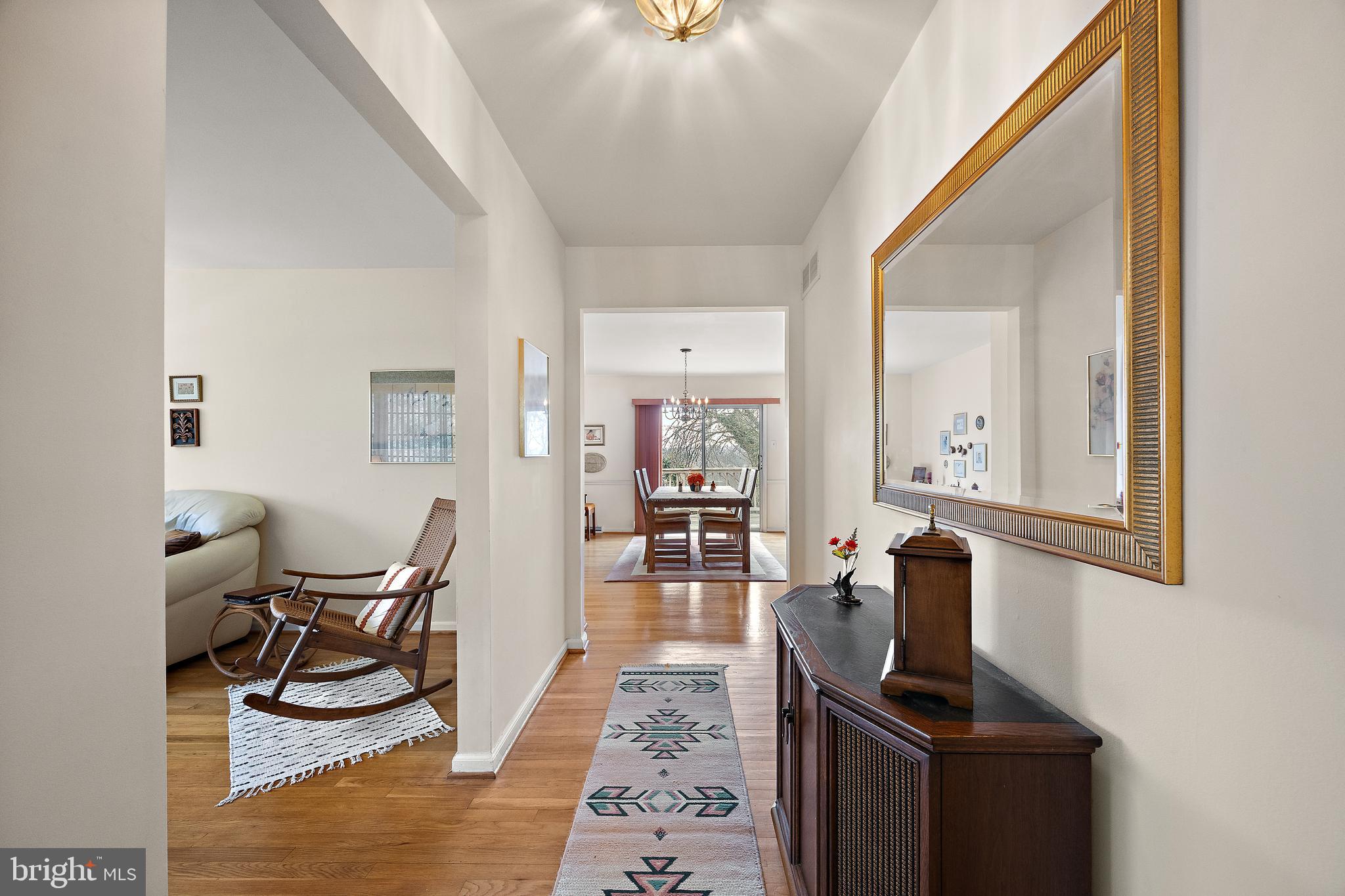 509 Holly Knoll Road Hockessin, DE 19707 - Photo 4 of 34 a living room with furniture a dining table and chairs with wooden floor
