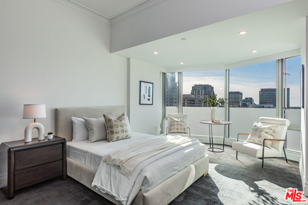 10727 Wilshire Boulevard, Unit 1702 Los Angeles, CA 90024 - Photo 20 of 43 a bedroom with a bed and glass floor