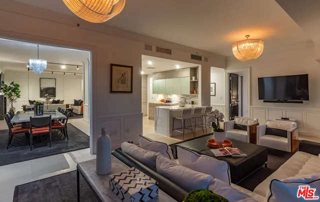 a dining room with furniture a rug and a chandelier