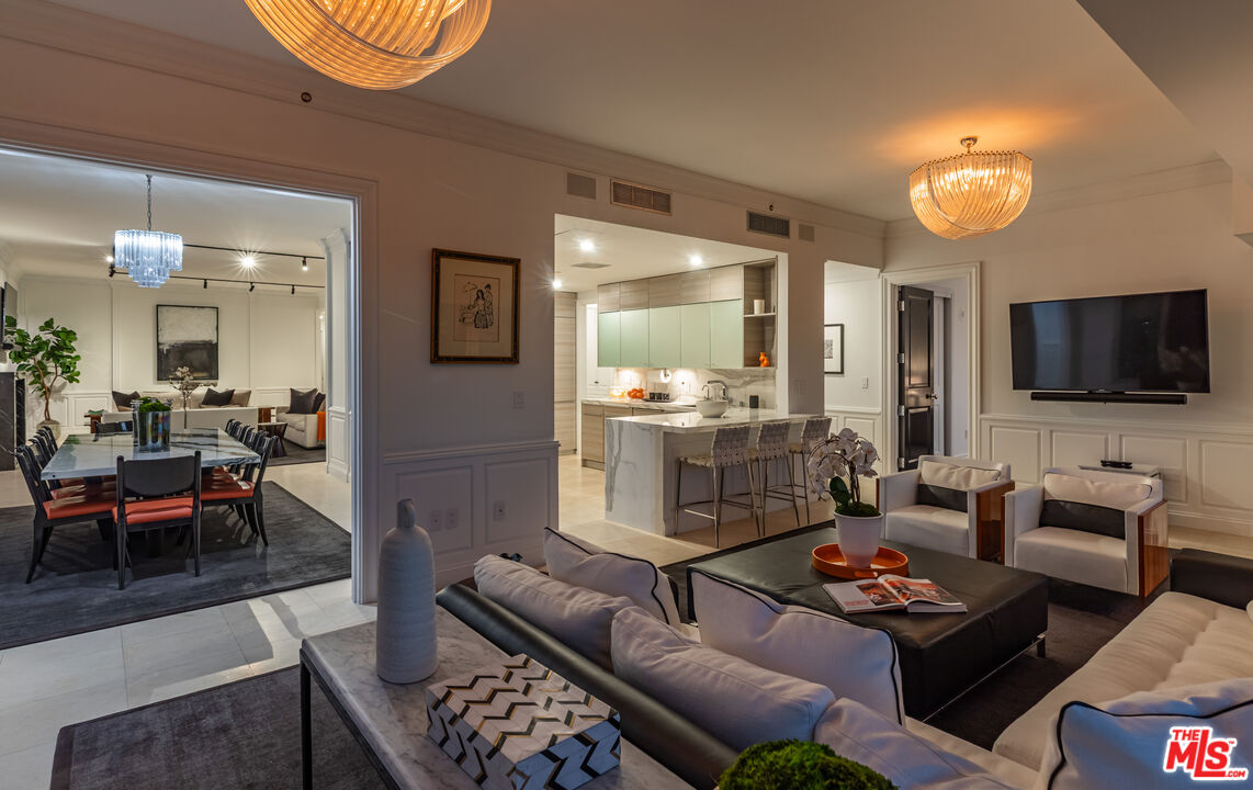10727 Wilshire Boulevard, Unit 1702 Los Angeles, CA 90024 - Photo 37 of 43 a living room with furniture and a flat screen tv