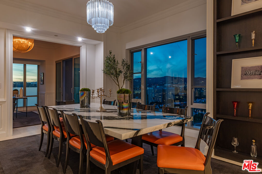 10727 Wilshire Boulevard, Unit 1702 Los Angeles, CA 90024 - Photo 38 of 43 a dining room with furniture a rug and a chandelier
