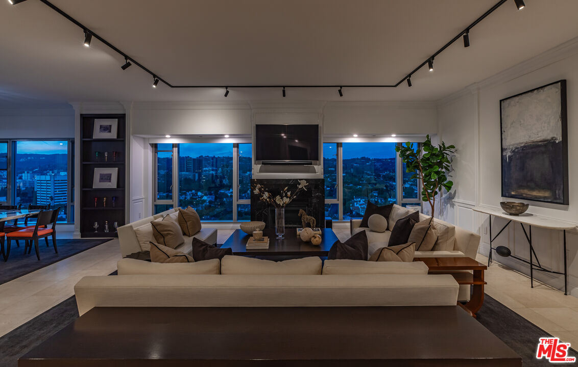 10727 Wilshire Boulevard, Unit 1702 Los Angeles, CA 90024 - Photo 39 of 43 a living room with furniture and a flat screen tv