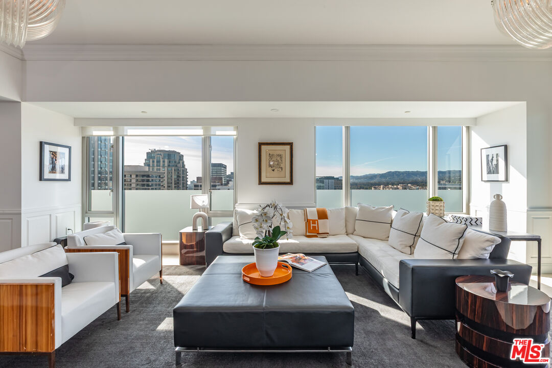 10727 Wilshire Boulevard, Unit 1702 Los Angeles, CA 90024 - Photo 7 of 43 a living room with furniture and a table