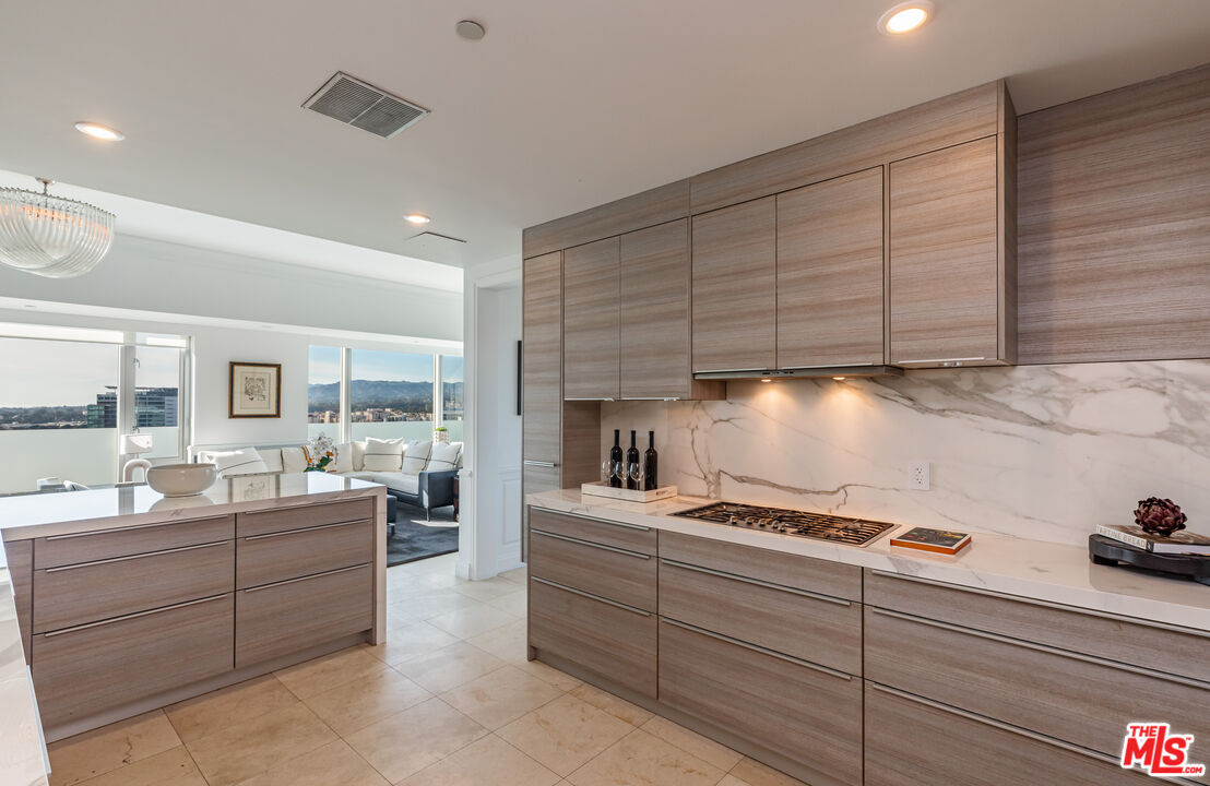 10727 Wilshire Boulevard, Unit 1702 Los Angeles, CA 90024 - Photo 9 of 43 a room with lot of cabinets and washer dryer