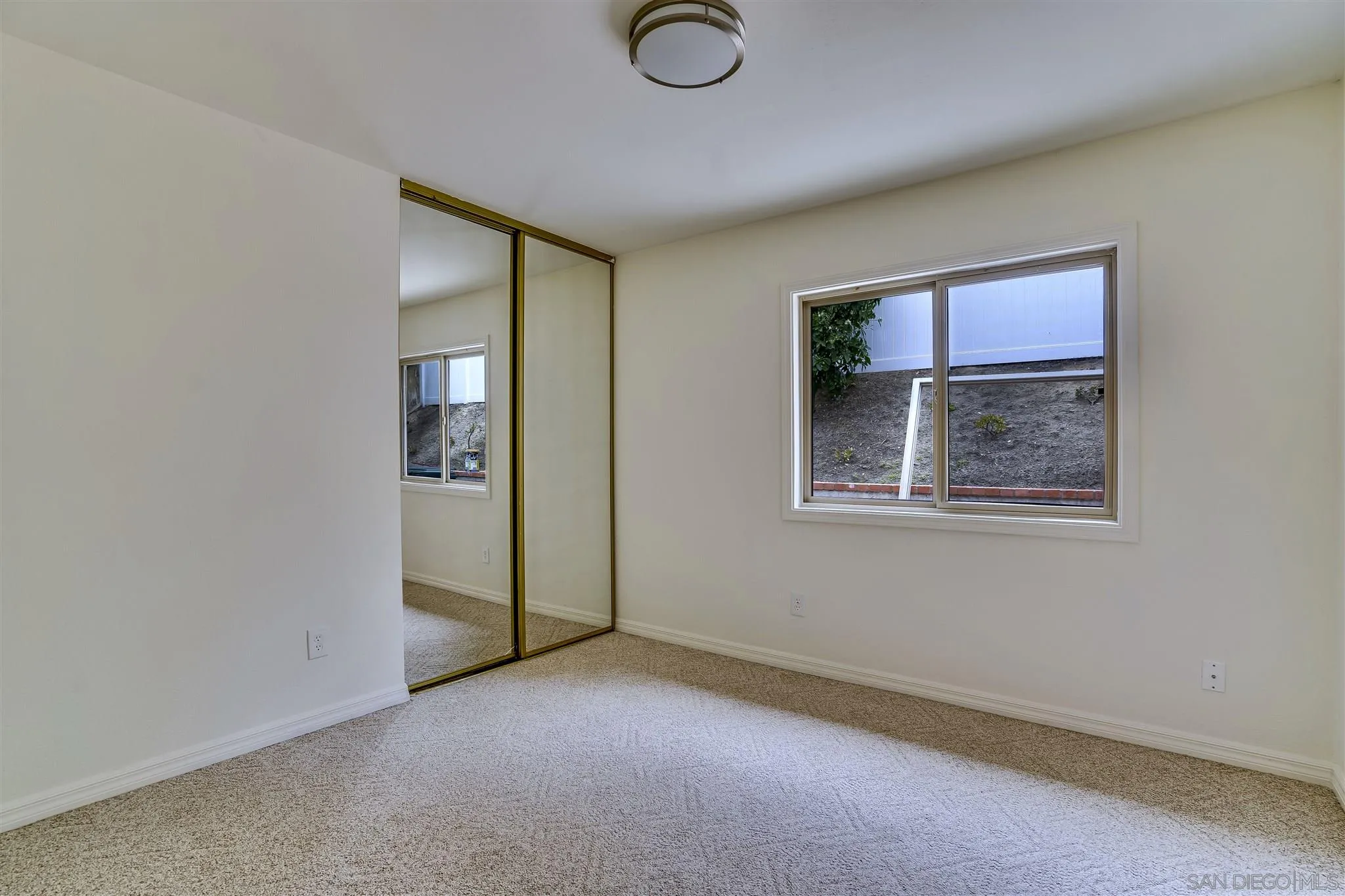 1975 Avenida La Posta Encinitas, CA 92024 - Photo 27 of 29 an empty room with windows and closet
