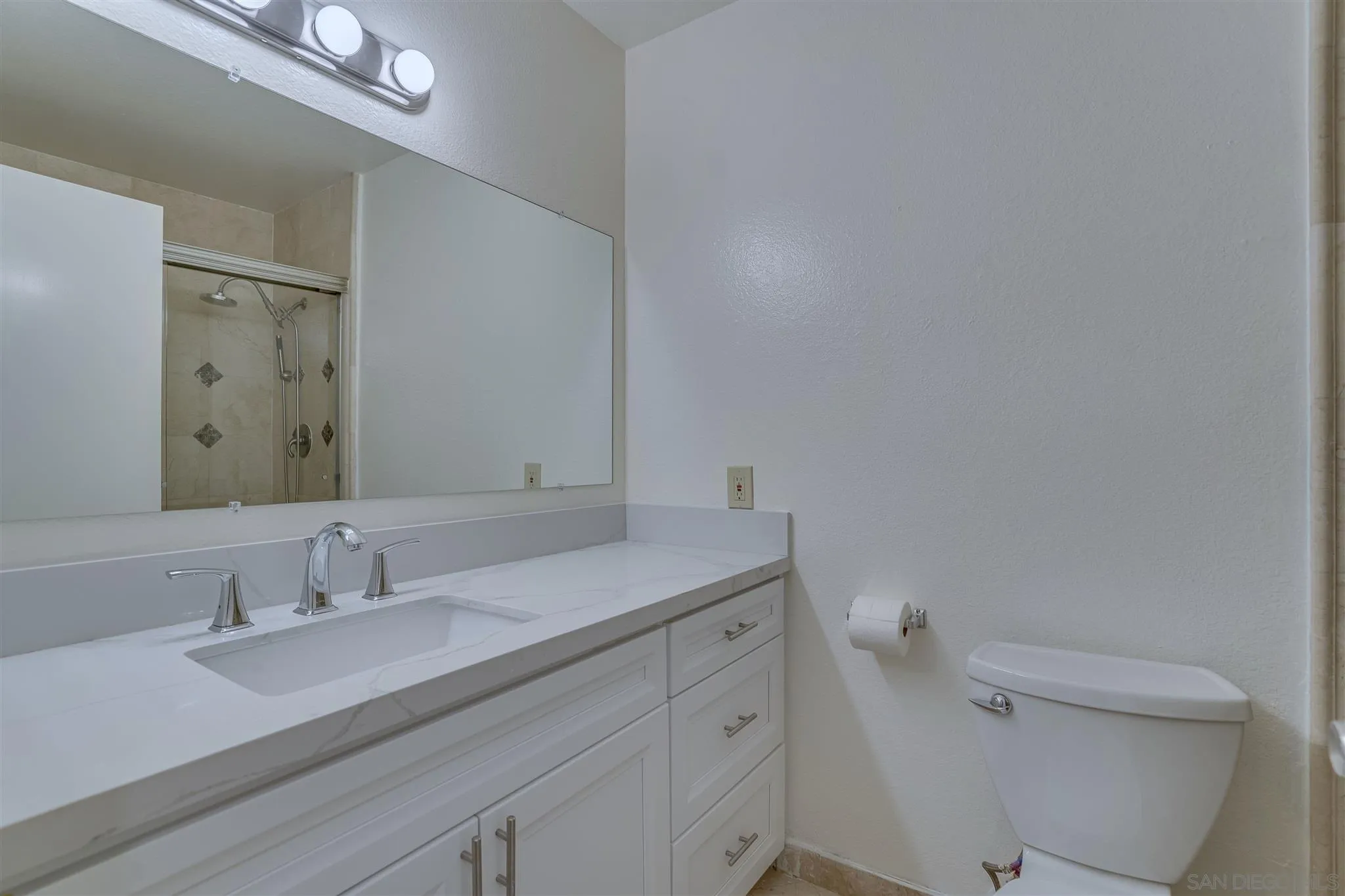 1975 Avenida La Posta Encinitas, CA 92024 - Photo 29 of 29 a bathroom with a granite countertop sink a toilet and a mirror