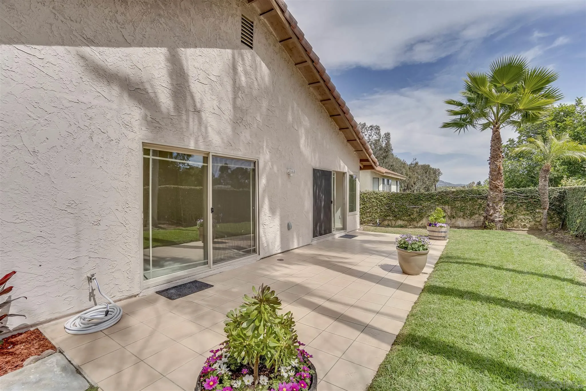 1975 Avenida La Posta Encinitas, CA 92024 - Photo 6 of 29 a view of a house with a yard and potted plants