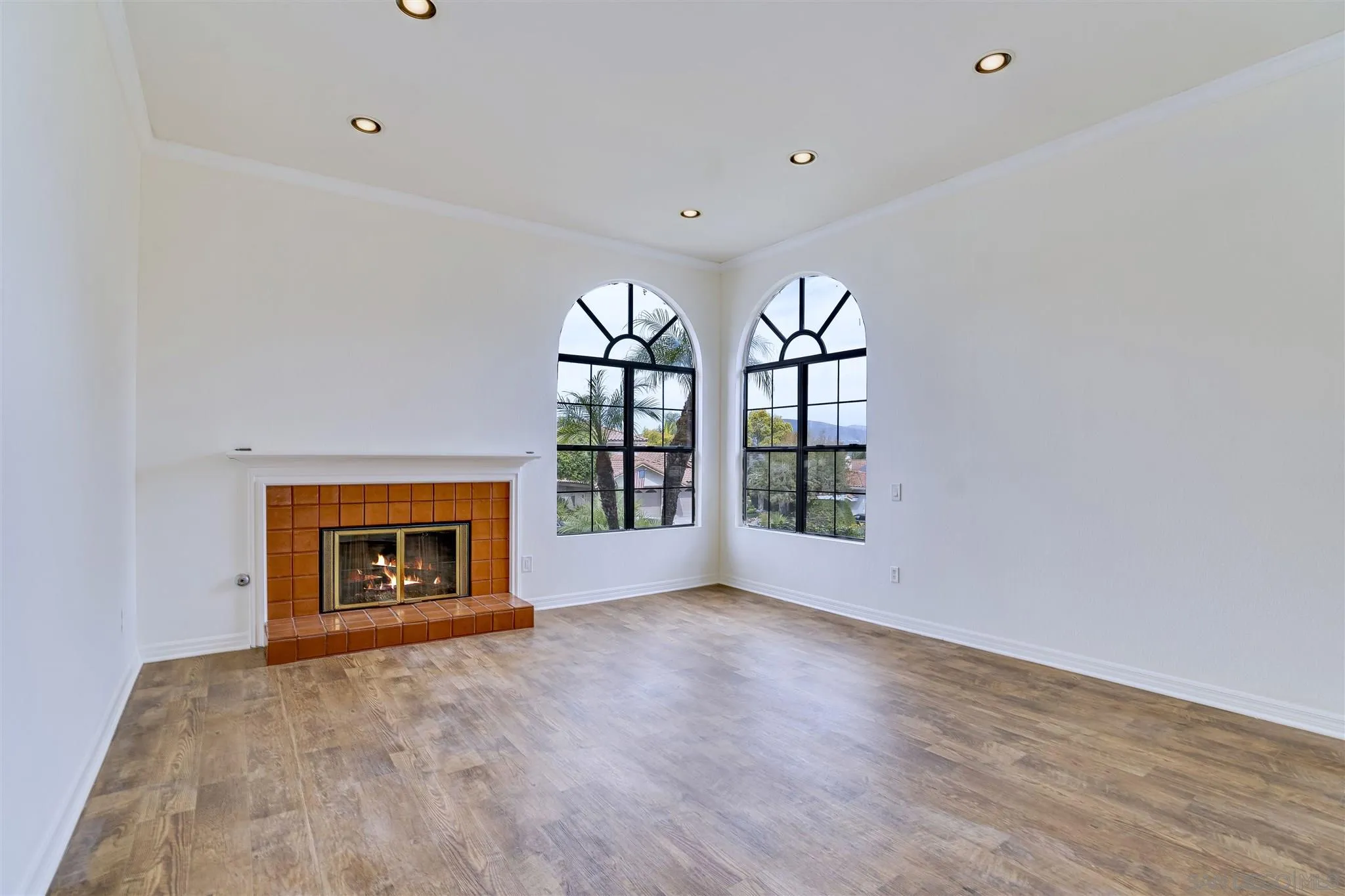 1975 Avenida La Posta Encinitas, CA 92024 - Photo 7 of 29 an empty room with large windows and fireplace