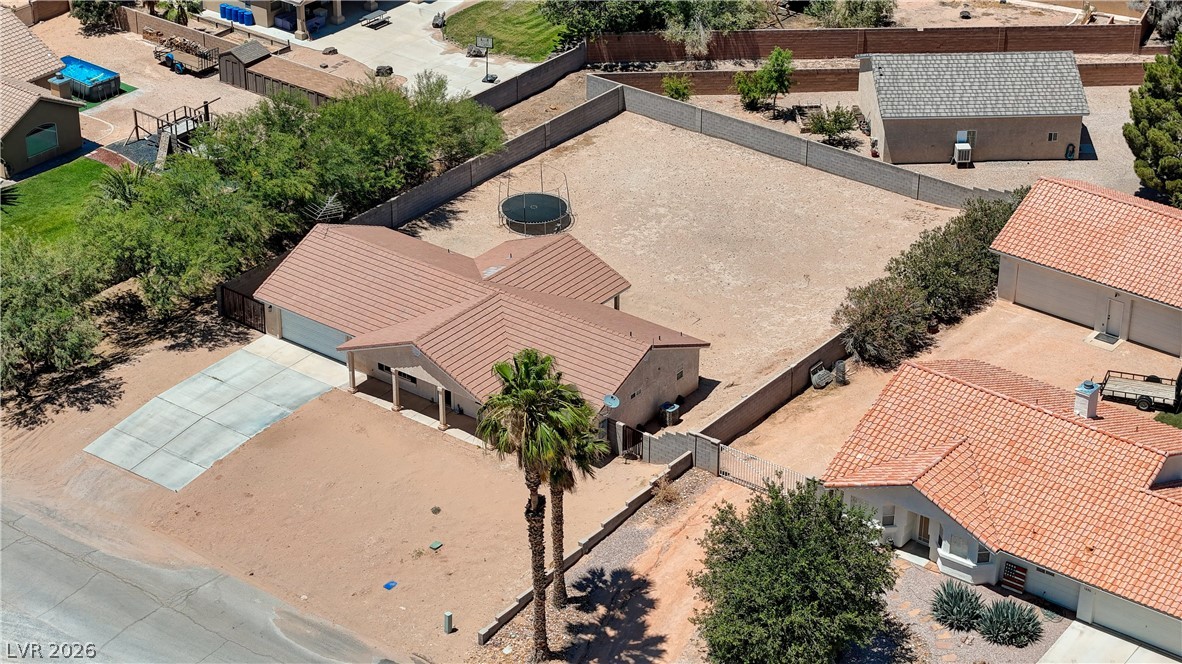 1272 Liston Avenue Logandale, NV 89021 - Photo 50 of 61 An aerial perspective reveals the property's expansive, fenced backyard, offering ample space for recreation and future landscaping.