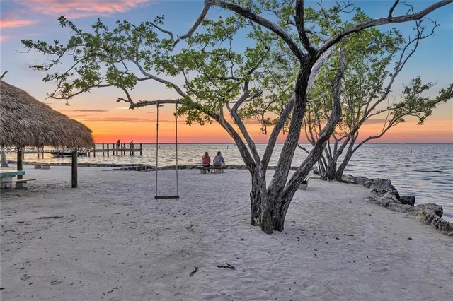 a living room with furniture and a kitchen view