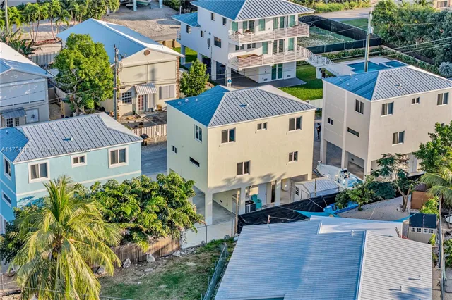 a view of a house with swimming pool and sitting area