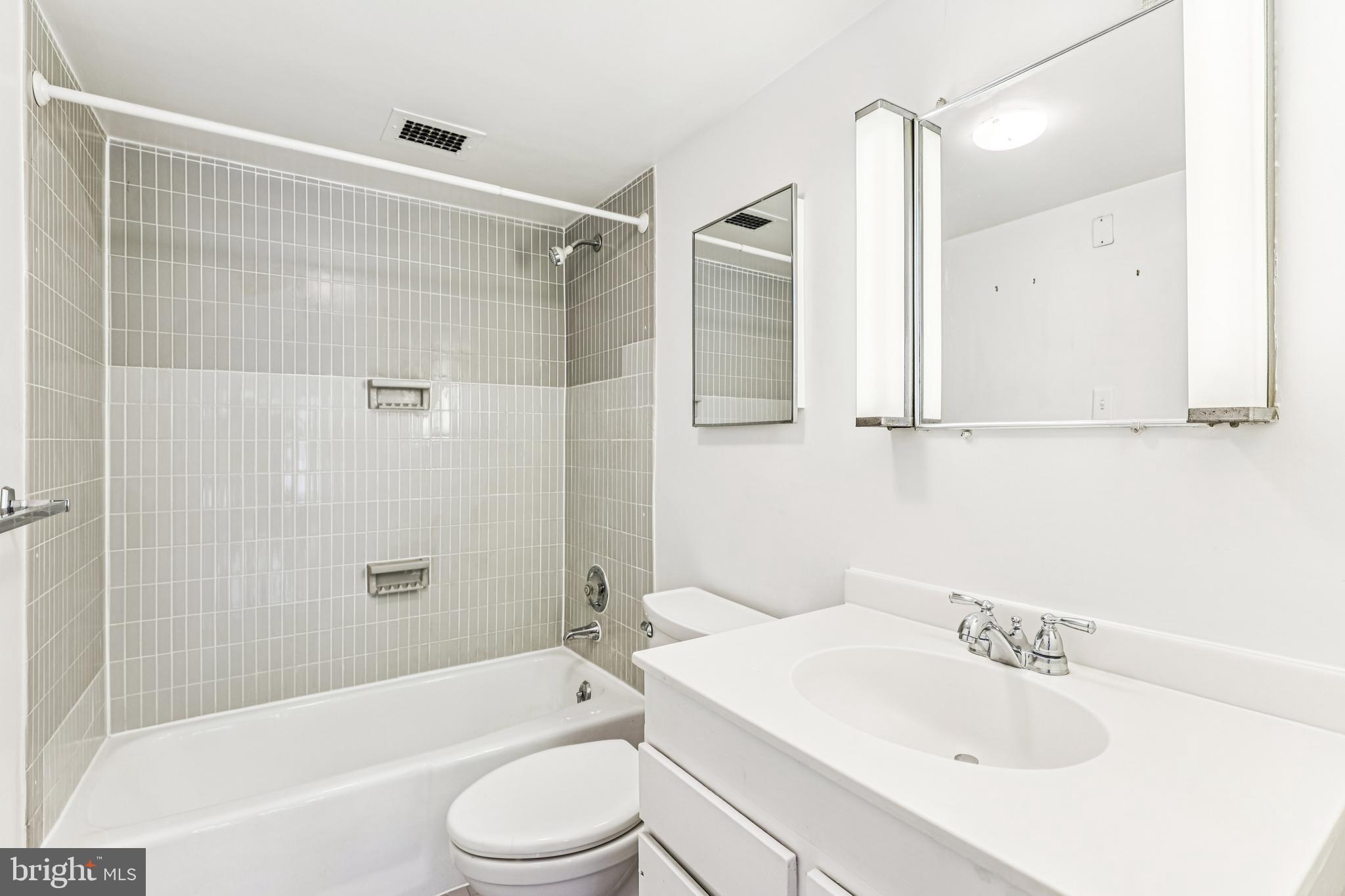 2500 Virginia Avenue Northwest, Unit 210S Washington, DC 20037 - Photo 13 of 25 a bathroom with a sink toilet and shower