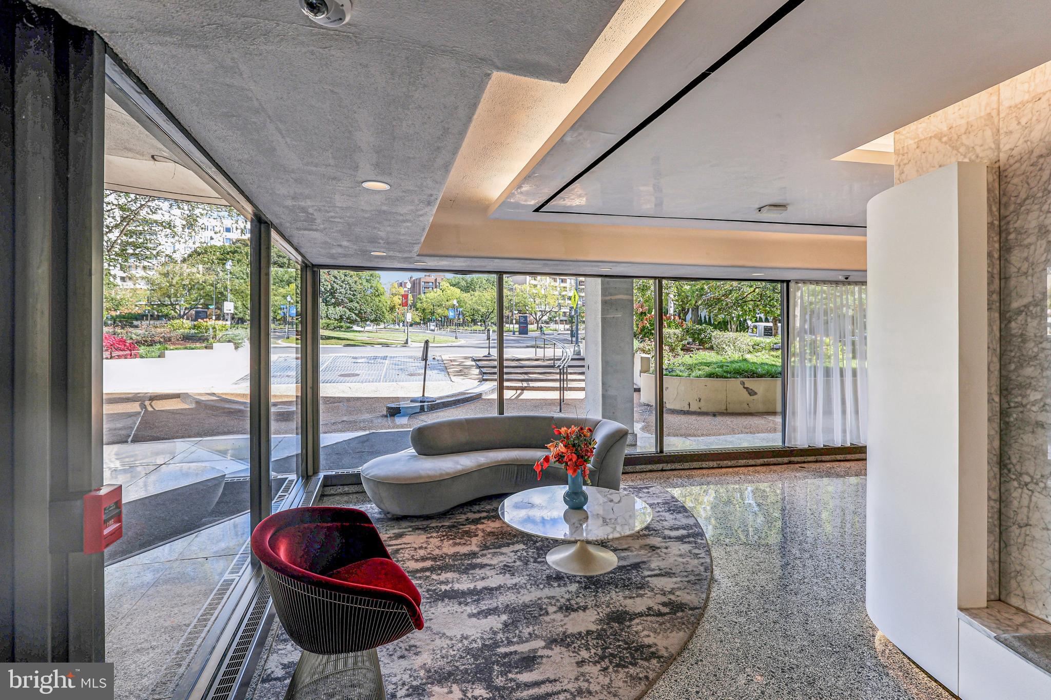 2500 Virginia Avenue Northwest, Unit 210S Washington, DC 20037 - Photo 15 of 25 a living room with furniture and a floor to ceiling window