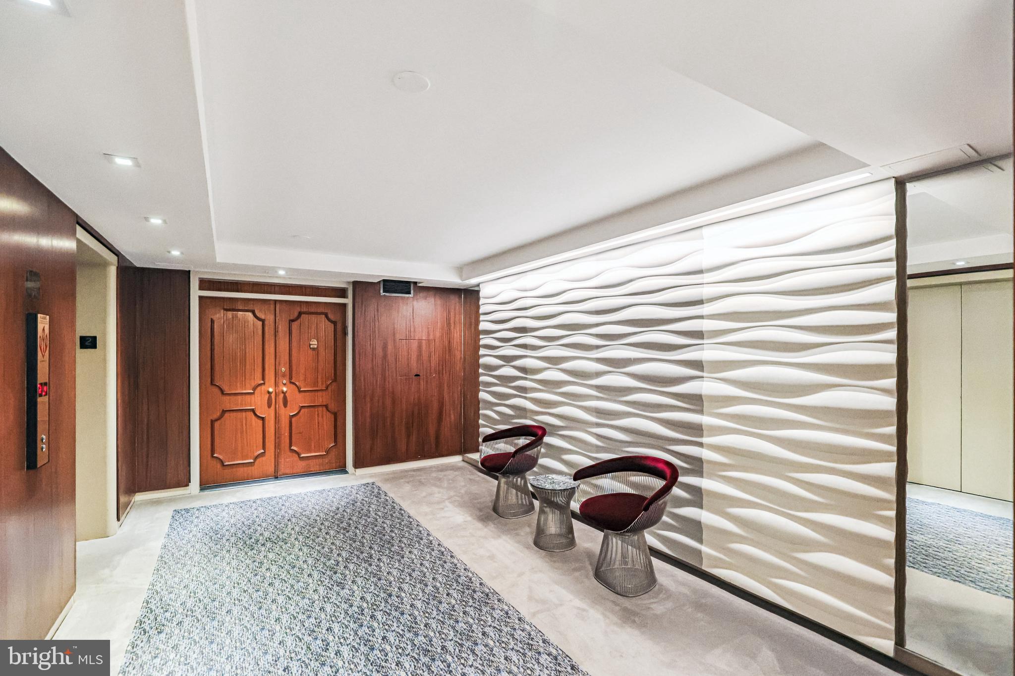 2500 Virginia Avenue Northwest, Unit 210S Washington, DC 20037 - Photo 3 of 25 a bedroom with a bed and a chandelier