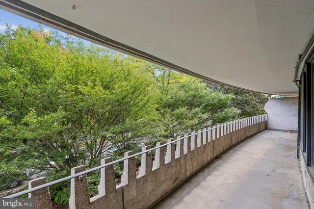 a view of an empty room with shelves and a large window