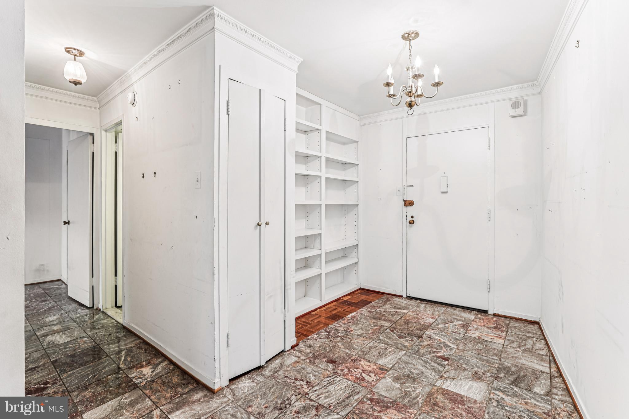 2500 Virginia Avenue Northwest, Unit 210S Washington, DC 20037 - Photo 4 of 25 a view of a hallway with closet and chandelier fan