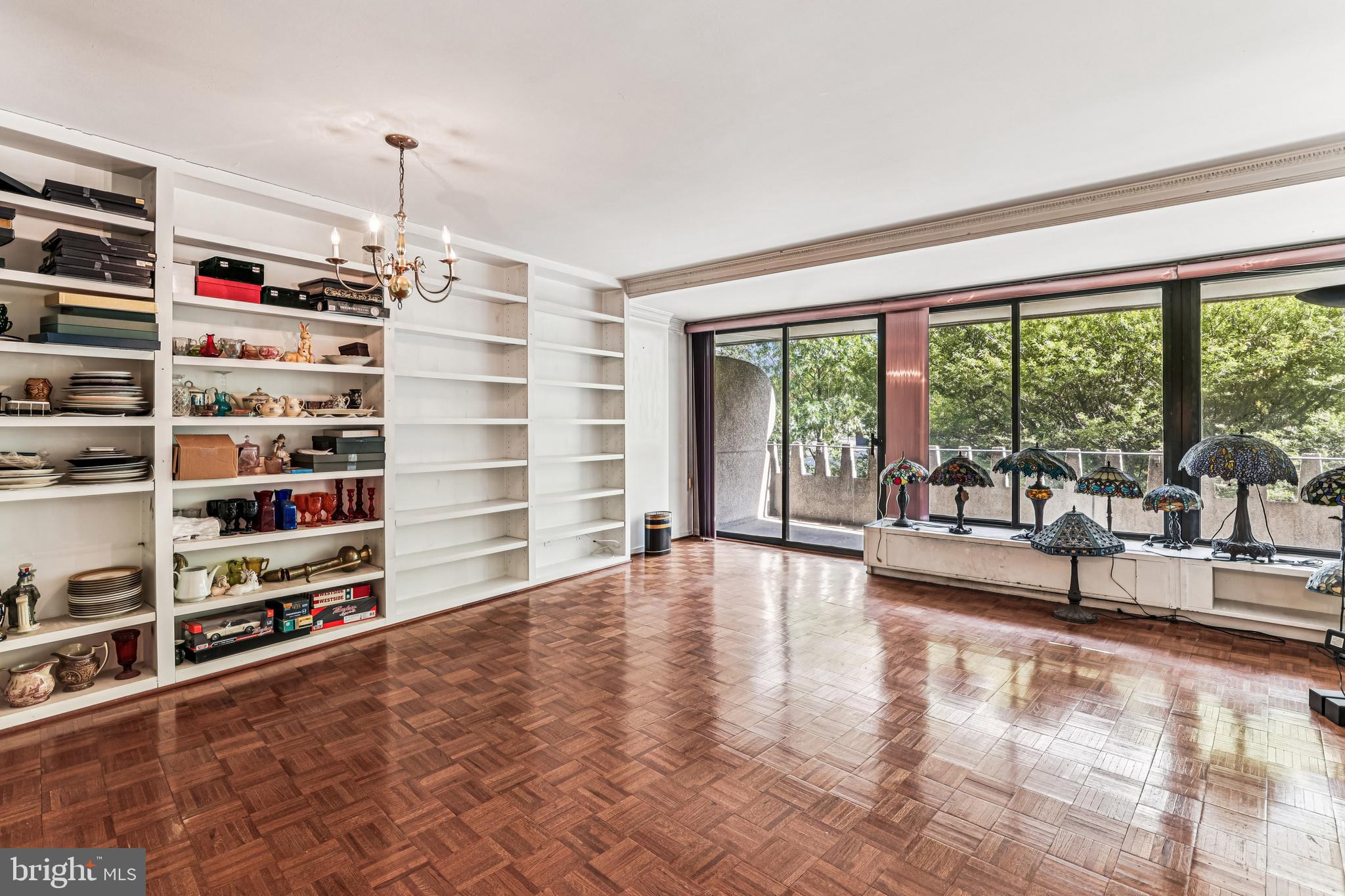 2500 Virginia Avenue Northwest, Unit 210S Washington, DC 20037 - Photo 5 of 25 a view of an empty room with shelves and a large window