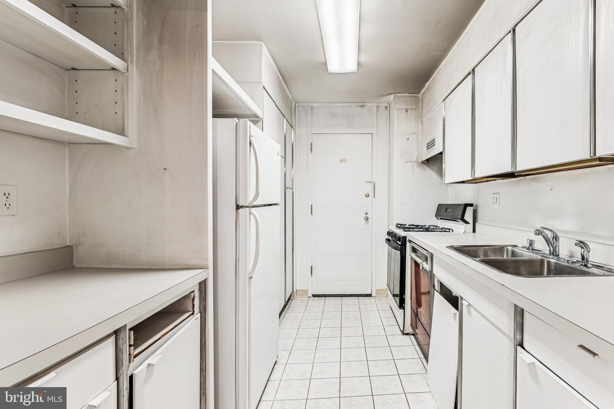2500 Virginia Avenue Northwest, Unit 210S Washington, DC 20037 - Photo 7 of 25 a kitchen with a sink and cabinets