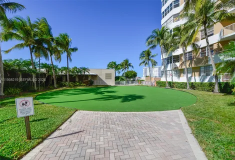 a front view of a house with a yard and potted plants
