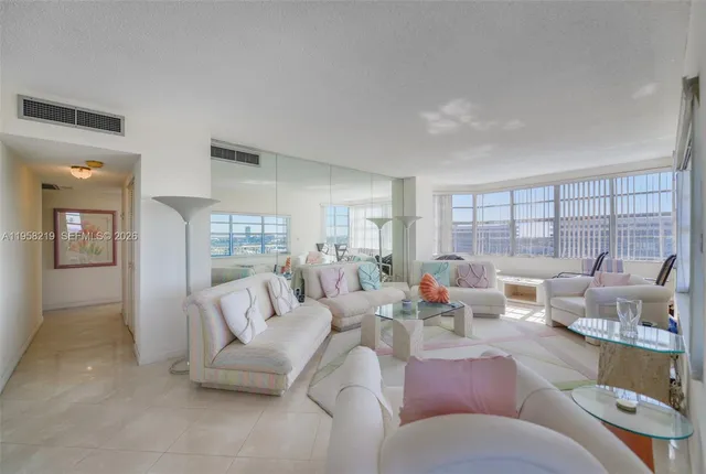 a living room with furniture and a large window