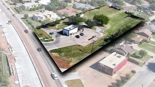 an aerial view of a residential houses with outdoor space