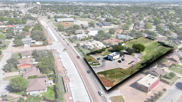 an aerial view of residential house with outdoor space and parking