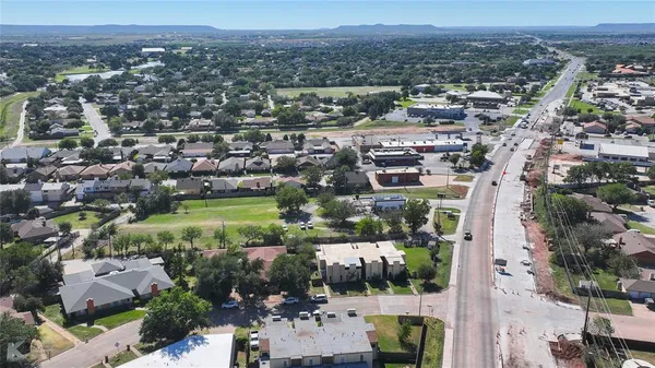 an aerial view of residential houses with outdoor space