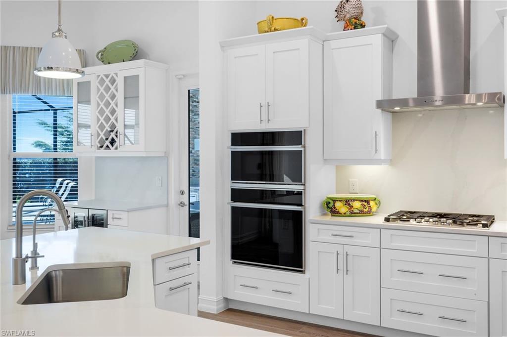 14630 Blue Bay Circle Fort Myers, FL 33913 - Photo 11 of 43 a kitchen with white cabinets and appliances