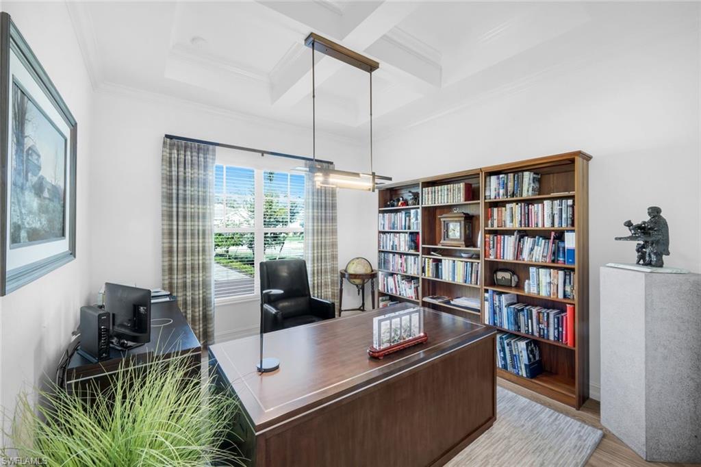 14630 Blue Bay Circle Fort Myers, FL 33913 - Photo 12 of 43 a living room with furniture a bookshelf and a large window