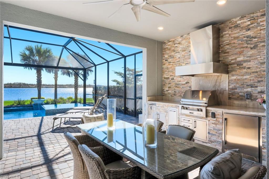 14630 Blue Bay Circle Fort Myers, FL 33913 - Photo 13 of 43 a living room with fireplace furniture and a floor to ceiling window